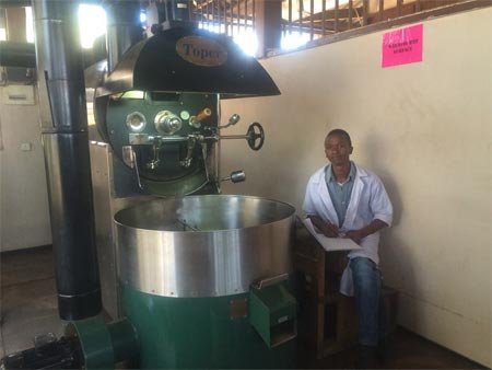 Roast master beside the Toper TX30 hot air roaster at Edelweiss Estate